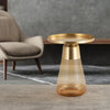 Amber round-top side table with a warm amber glass base, styled in a contemporary living room for a luxurious touch.
