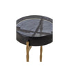 Close-up of a round black accent table with a glass top and gold twisted metal legs, showcasing its modern and elegant design.