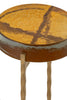 Close-up of an amber-colored tabletop with a glossy finish, resting on a sturdy metal frame with uniquely textured legs for elegance.