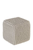 Beige square pouf with a knitted texture, offering a soft and compact design perfect for seating or decor in cozy home spaces.