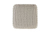 Top-down view of a beige cube-shaped pouf with tightly knit woven texture, offering a modern accent for versatile home decor.