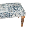 Elegant bench with vintage-patterned upholstery in blue and white, featuring intricately carved wooden legs for timeless decor.