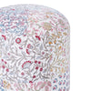 Close-up of a round pouf with intricate multicolor floral designs in red, yellow, and blue, showcasing detailed patterns on white fabric.