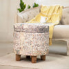 Beige vintage-style storage ottoman with detailed patterns and wooden legs, adding a warm, functional accent to cozy interiors.