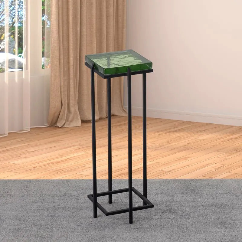 Albany Living T505 drink table with green glass top, black metal frame, set on a light wood floor with beige curtains and natural light.