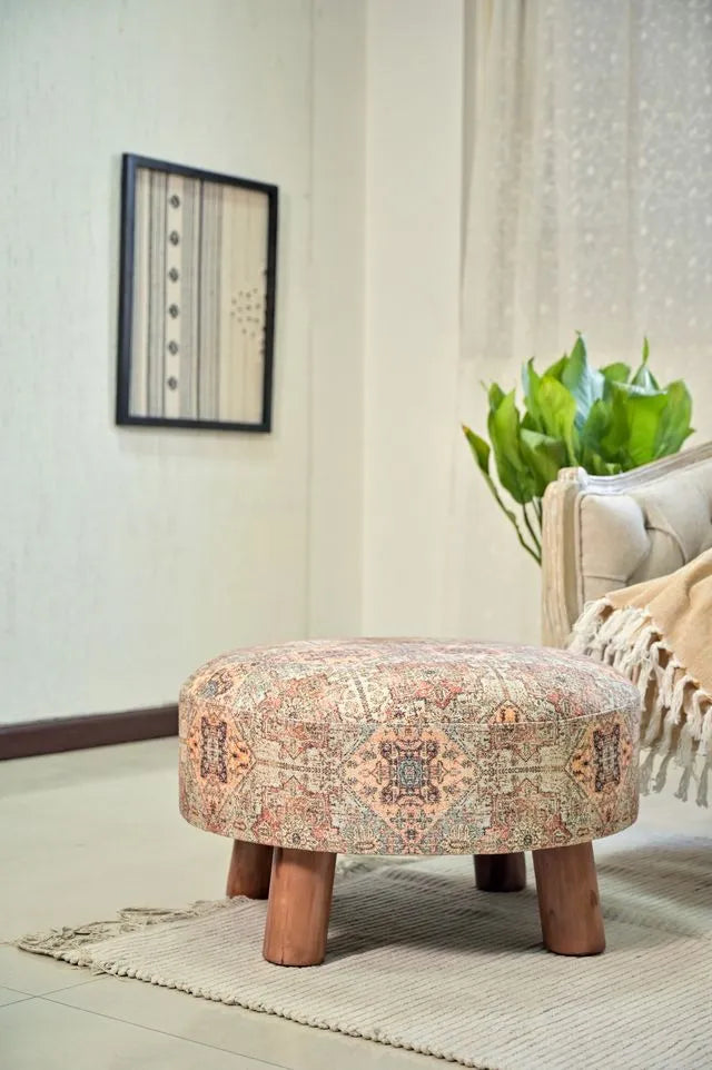 Brown ethnic stool with detailed multicolored patterns and sturdy wooden legs, perfect for adding rustic charm to any room.