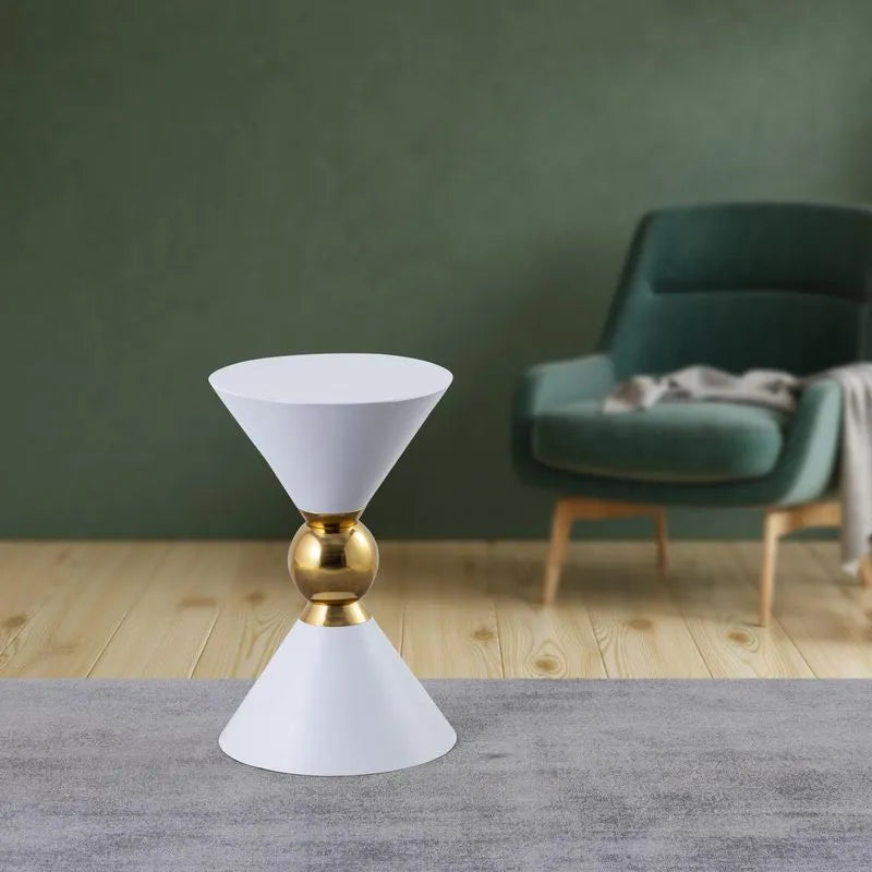 White modern accent table with gold spherical detail, placed in a cozy living room setting, offering elegant and minimalist design.