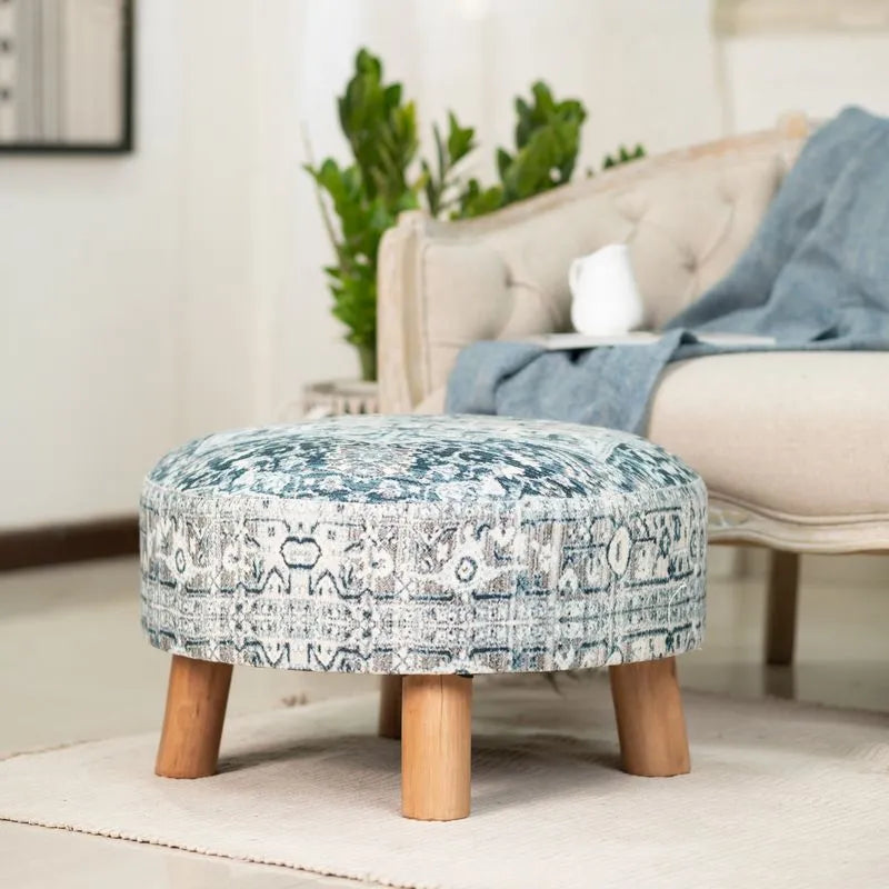 Albany Living 23 Ethnic Stool blue with bamboo legs and blue patterns, adding rustic charm to a cozy living room with a beige sofa.