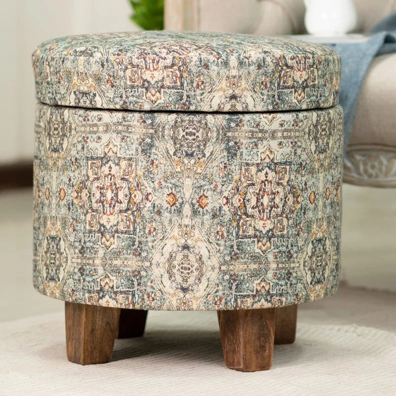 Vintage-style teal storage ottoman with intricate multicolored patterns, sturdy wooden legs, perfect for enhancing traditional interiors.