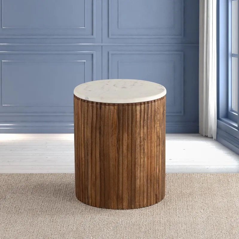 Cylindrical wooden table with a white marble top, placed in a room with blue wall paneling, showcasing a natural wood finish.