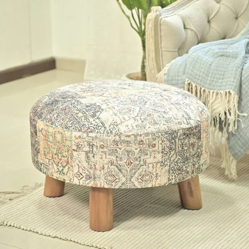 Albany Living 23 Multicolored Ethnic Stool beige with bamboo legs, showcasing rustic charm and intricate patterns in a cozy living space.