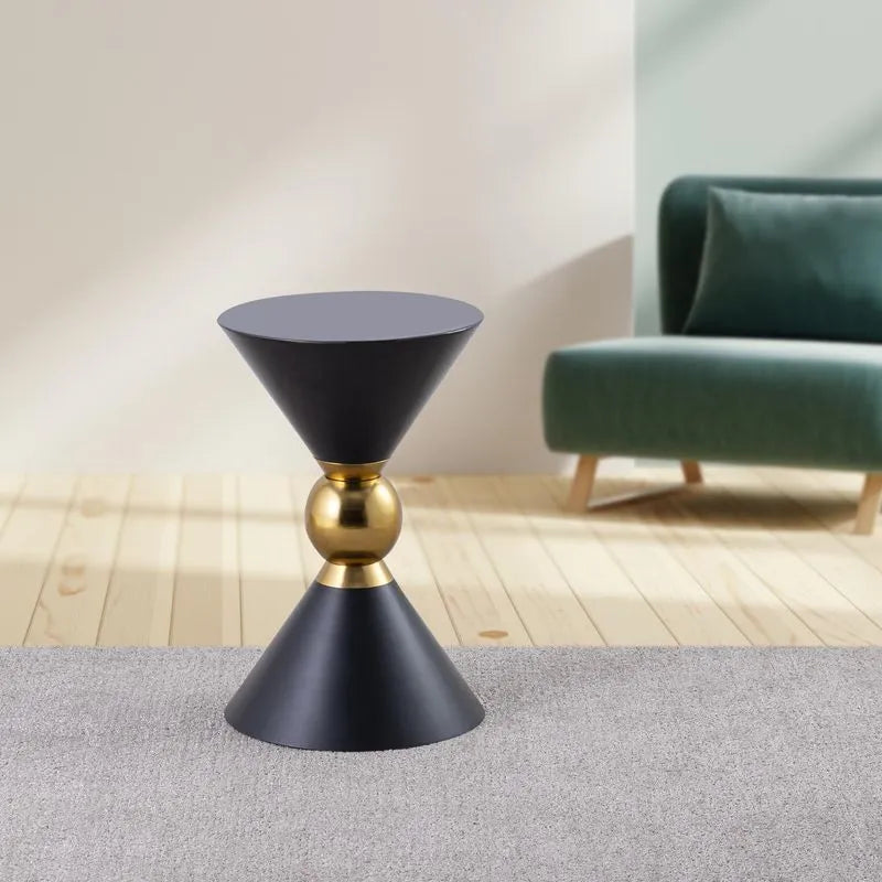 Black accent table with a gold centerpiece, featuring a unique cone-shaped design, placed in a modern living room setting.